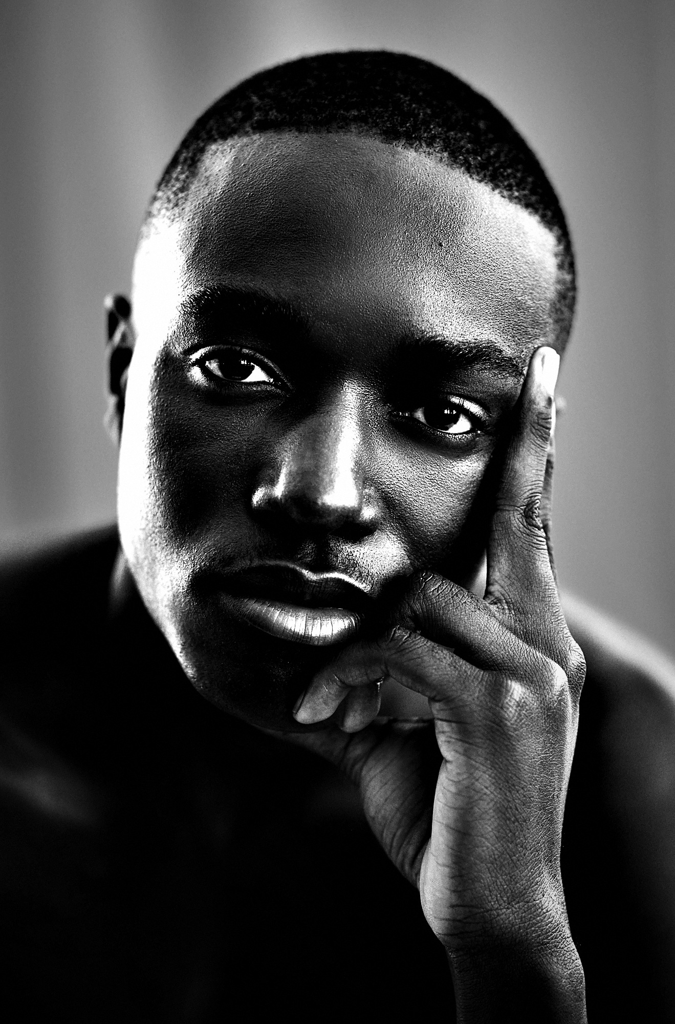 High-contrast black and white editorial portrait of a man